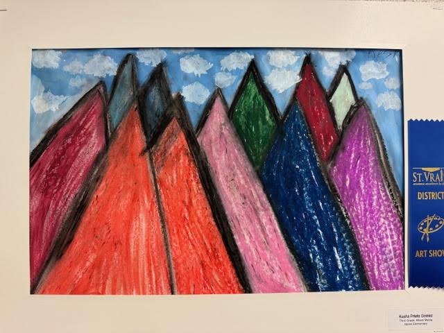 Colorful mountains in shades of red, pink, green, blue, and purple under a blue sky with fluffy clouds. Art exhibit ribbon displayed.