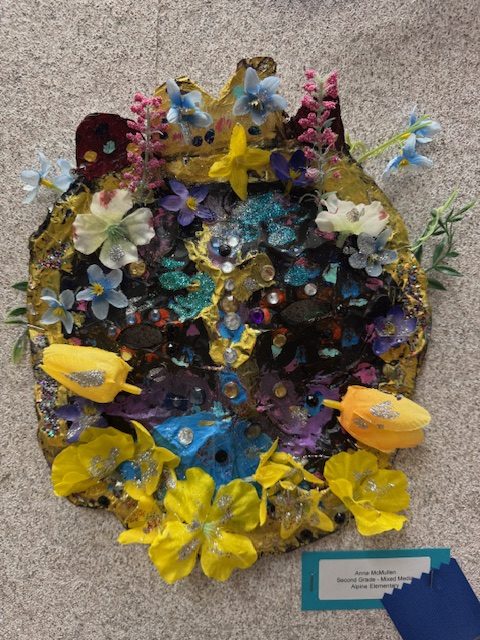 Colorful artwork featuring flowers, glitter, and various textures, showcasing creativity and vibrant design elements.